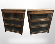 A pair of Gumm glazed oak three tier stacking bookcases, each 87 cm x 25 cm x 112 cm.