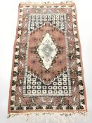 An Iranian rug, on salmon ground,