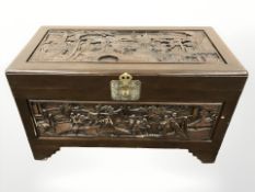 An oriental carved camphor wood blanket chest, width 102 cm.