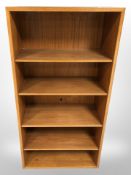 A teak open bookcase, 61 cm x 29 cm x 120 cm.
