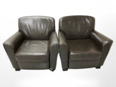 A pair of contemporary stitched brown leather armchairs.