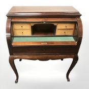 A 20th century mahogany cylinder front bureau on paw feet, 91 cm x 55 cm x 110 cm.