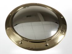 A brass convex port hole shaped mirror, diameter 38 cm.