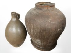A stoneware wine jug and a large terracotta vessel, height 40 cm.