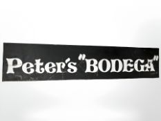 A painted sign 'Peter's Bodega', 99 cm x 20 cm.