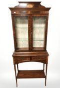 A reproduction inlaid mahogany display cabinet fitted with two drawers,