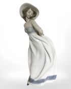 A Nao figure of a lady in a summer dress, height 33 cm.
