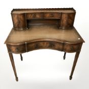A Chapman's siesta reproduction mahogany ladies serpentine front writing desk,
