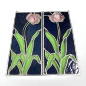 A pair of stained and leaded glass panels depicting flowers, each 49 cm x 22 cm.