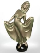 A painted chalk figure of a lady in flapper dress, height 45 cm.