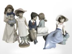 Four Nao figures of boys and girls.