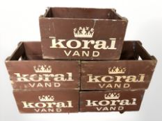 Five Koral painted pine bottle crates, width 42 cm.
