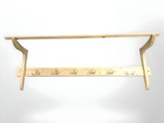 A pine coat rack, width 115 cm.