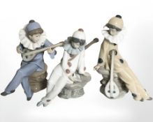 Three Nao figures of harlequin musicians.