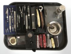A group of precision drawing instruments, Swiss army knives, compass, cutthroat razor, etc.