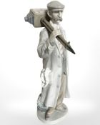 A Lladro figure of a photographer.