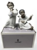 A Lladro figure 'Angel with flute' No. 4540, boxed, and a further figure No. 4537.