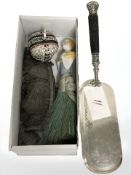 An EPNS crumb scoop with antler handle, porcelain half doll,