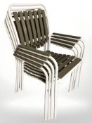 A set of four metal framed stackable garden armchairs.
