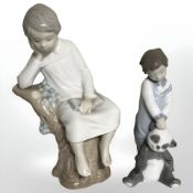 A Lladro figure of a boy sat on a tree stump and a further figure of a boy with a panda.
