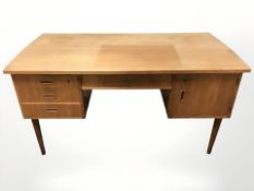A 20th century Danish teak twin pedestal writing desk, 149 cm x 76 cm x 76 cm.