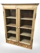 A glazed pine double door cabinet, 95 cm x 34 cm x 126 cm.
