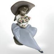 A Lladro figure of a girl holding a bouquet of flowers, No. 5862.
