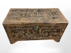 An oriental carved camphor wood blanket chest, width 89 cm.