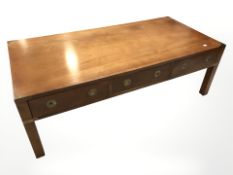 A brass mounted teak campaign style rectangular low coffee table, fitted three drawers,