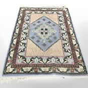 A Tunisian rug on blue ground, 177 cm x 123 cm.