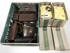 A collection of vintage cameras and related accessories, leather camera bags,