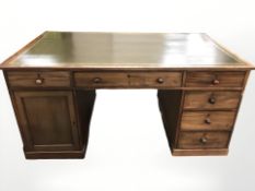 A Victorian mahogany twin pedestal partners desk with green leather inset top,