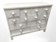 A painted pine twelve drawer chest, 103 cm x 43 cm x 84 cm.