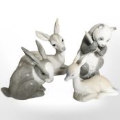 A Nao panda, rabbit and two recumbent deer.