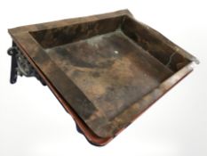 A rectangular copper planter with painted cast iron wall mounting bracket,