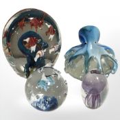 Four nautical theme glass paperweights
