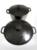 Two enameled cast iron lidded twin handled cooking pots, largest 32 cm wide.