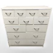 A painted pine eleven drawer chest, 93 cm x 40 cm x 101 cm.