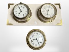 A ships style brass cased timepiece and barometer mounted on board,