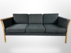 A late 20th century Danish wooden framed three seater settee in charcoal fabric,