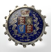A Victorian enameled half crown mounted as a brooch.