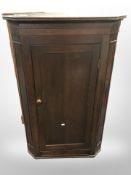 A 19th century oak hanging corner cabinet,