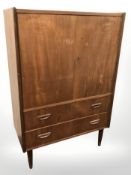 A 20th century Danish teak double door cabinet, 80 cm x 40 cm x 120 cm.