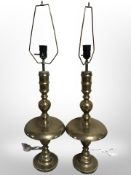 A pair of Indian engraved brass candlesticks converted into lamp bases,