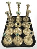 Six pairs of brass candlesticks