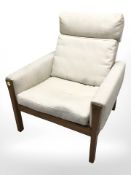 A Danish teak armchair in oatmeal fabric.