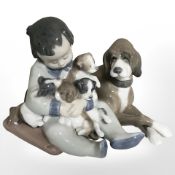 A Lladro figure group of a boy with puppies, No. 5456.