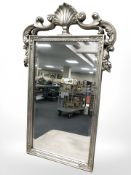 An ornate silvered mirror, 105 cm x 63 cm.
