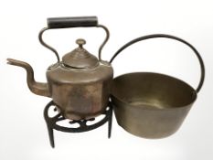 An antique brass jam pan, diameter 18 cm, together with a Victorian kettle and a trivet stand.