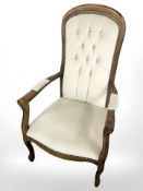 A reproduction armchair in button draylon
